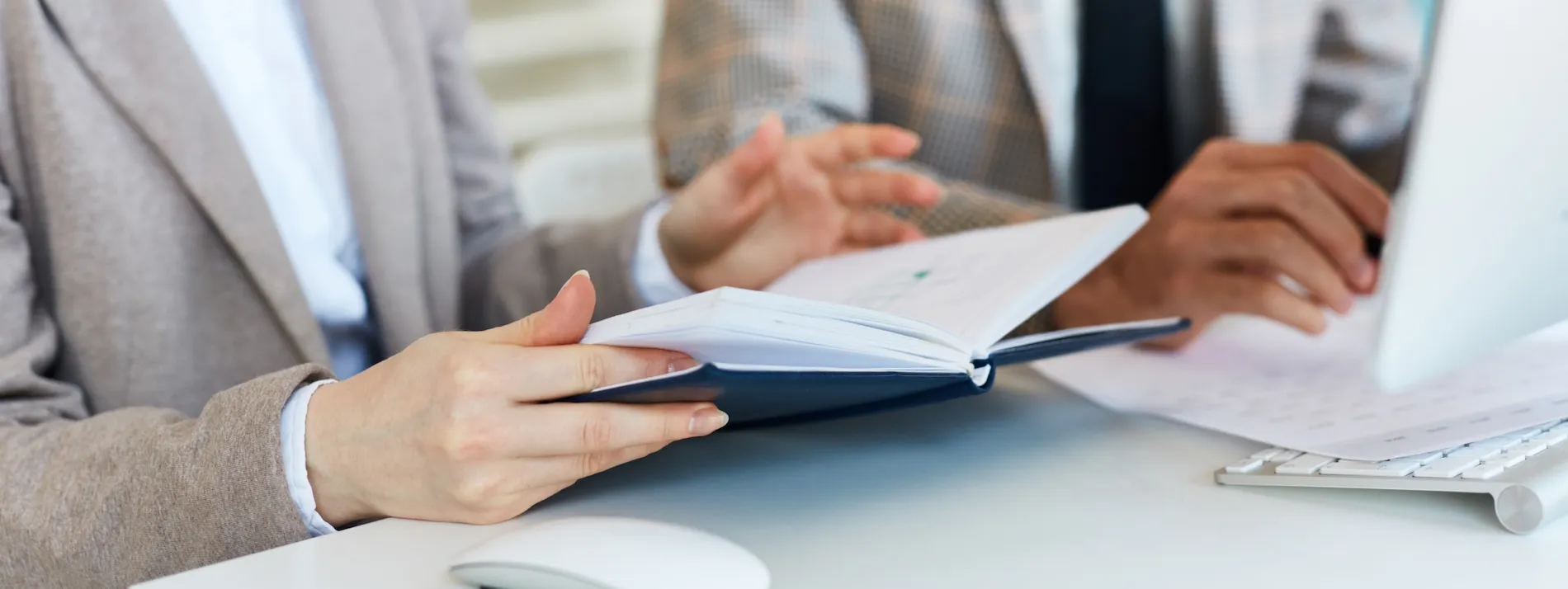 Person sorting paperwork while waiting on a government call