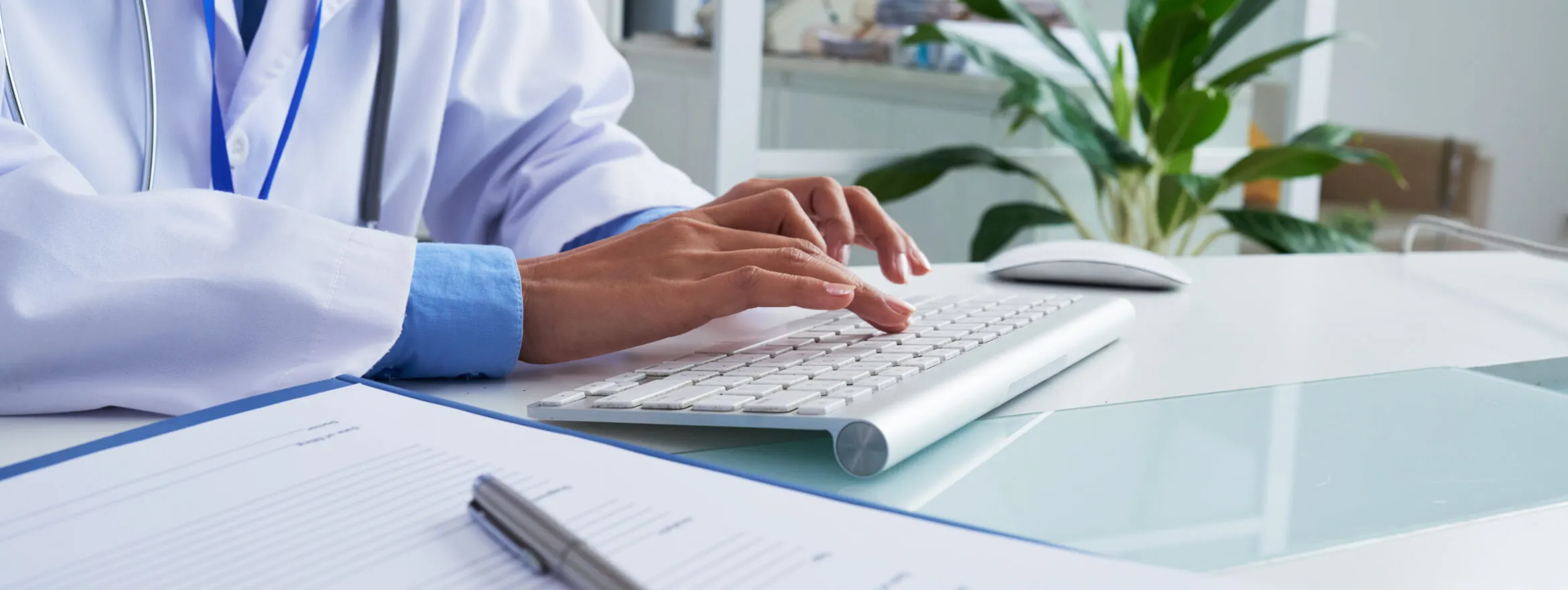 Medical billing specialist typing at a desk