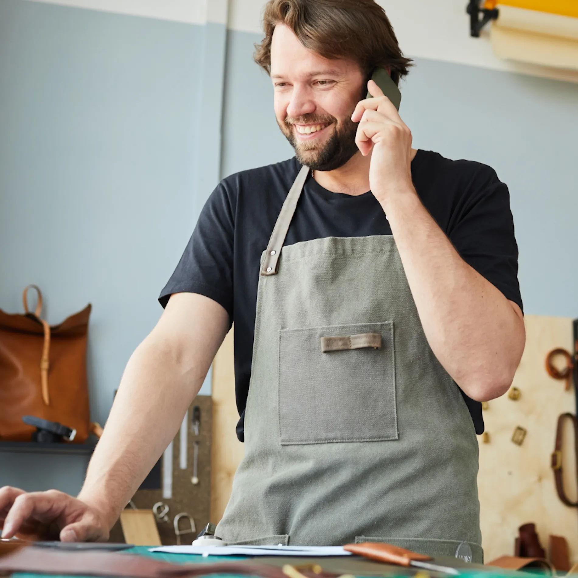 Small business owner on a phone call at the counter